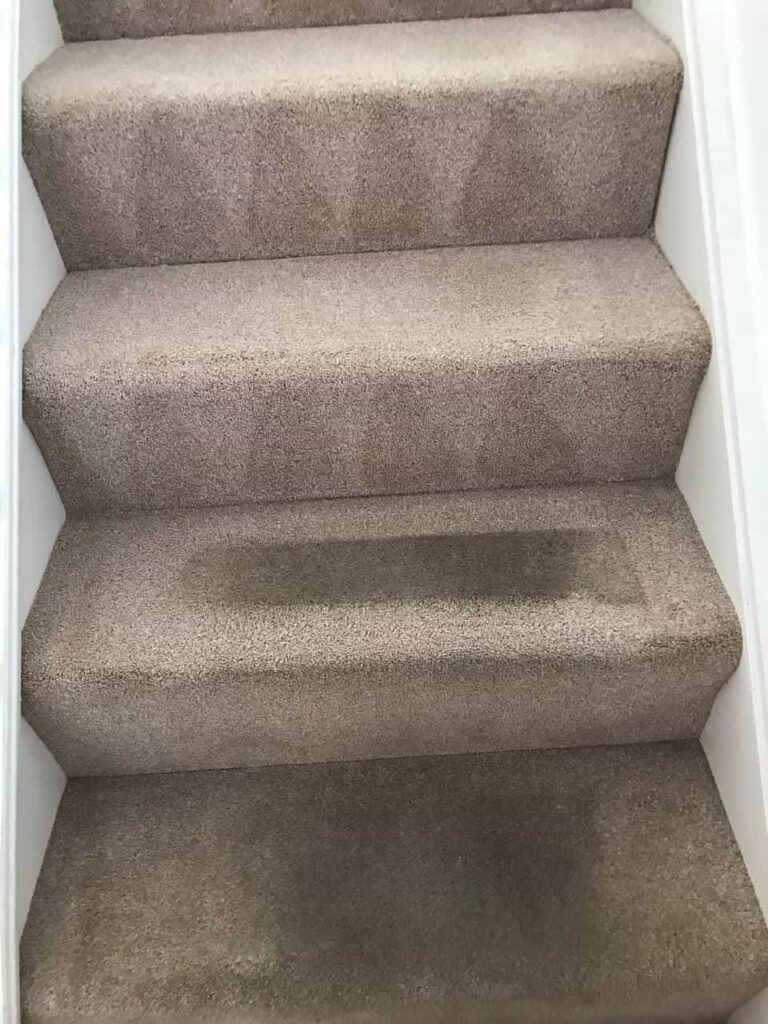 this is a photo of a staircase with beige carpets that is in the process of being cleaned works carried out by Tooting Carpet Cleaning